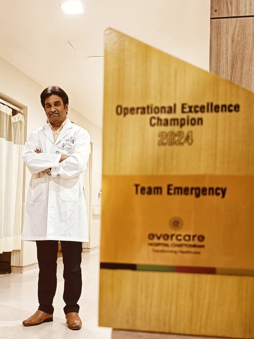 Dr. Rivu Raj Chakraborty beside the Operational Excellence Champion 2024 award won by the emergency team