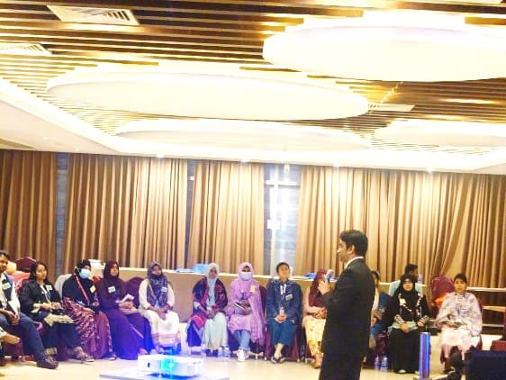 Lecturing to a hall of trainees at a continuing medical education programme